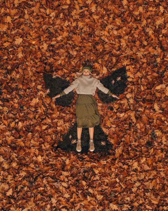 Woman in a cozy fall outfit with a knit sweater and midi skirt.