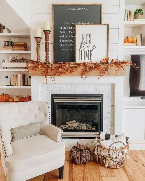 Modern farmhouse fall mantel with warm autumn garland and cozy accents.