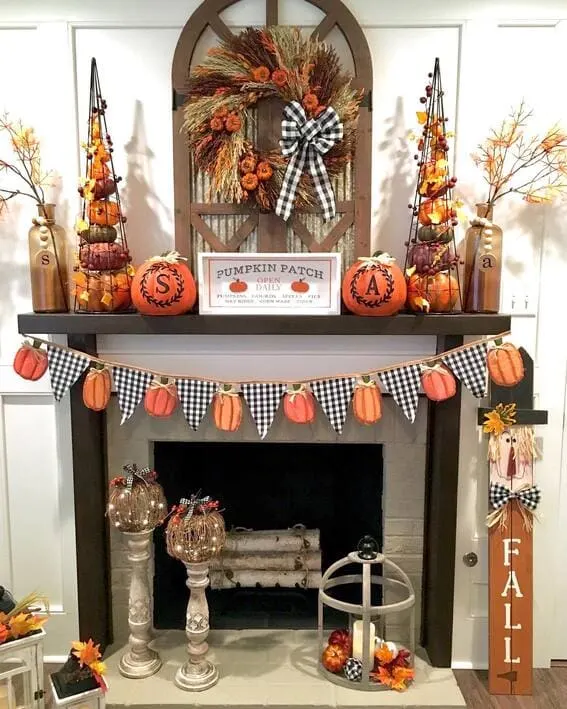 Festive fall mantel with pumpkins, wreath, and gingham accents.