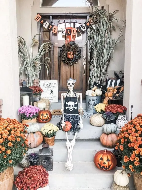 This porch is full of Halloween cheer, with a seated skeleton dressed in a pirate-themed outfit stealing the show!