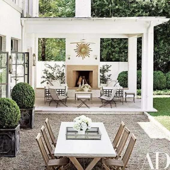 Modern outdoor pavilion with an elegant fireplace as well as a cozy seating area.