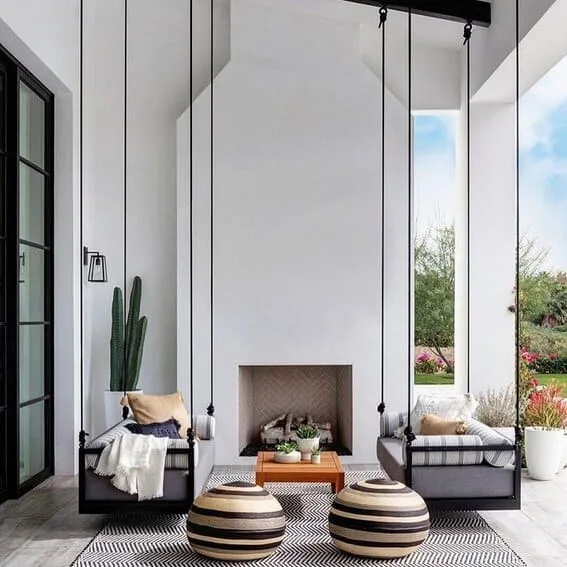 Modern patio with modern fireplace with stylish swing seating.