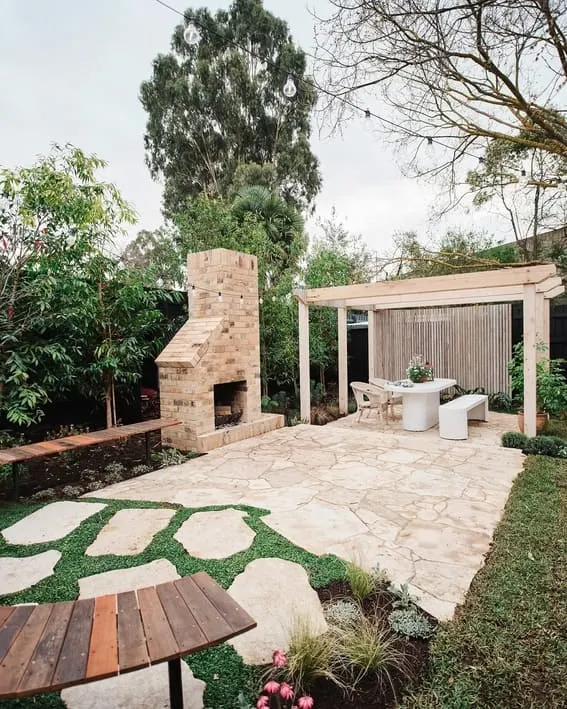 Beautiful backyard patio featuring an impressive brick fireplace as well as comfortable seating area.