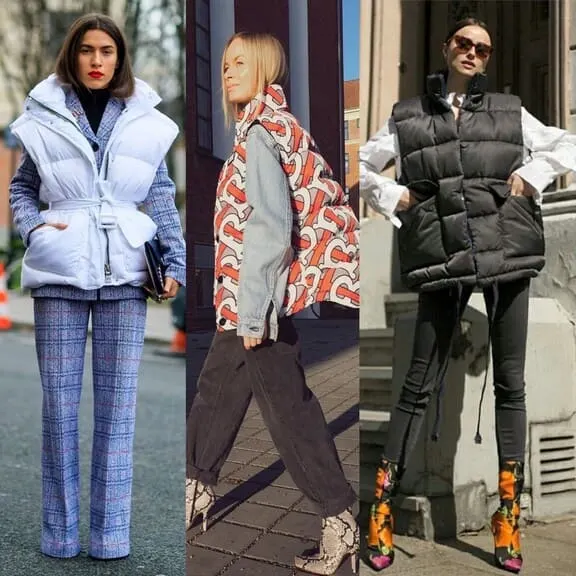 Three women wearing puffer vests in different styles: one in a white belted puffer vest with a plaid suit, another in a printed puffer vest over a denim jacket, and the third in an oversized black puffer vest with skinny pants and vibrant boots.